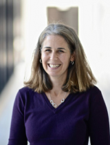 Portrait photo of smiling Dr. Jennifer Marlon against bright, blurred background.